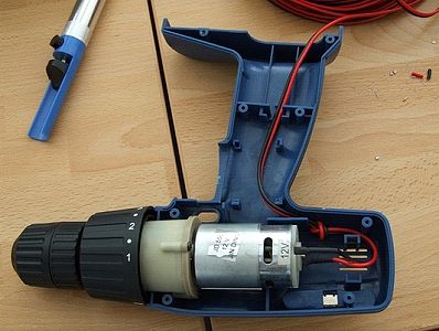 The motor returns to its housing, leads attached